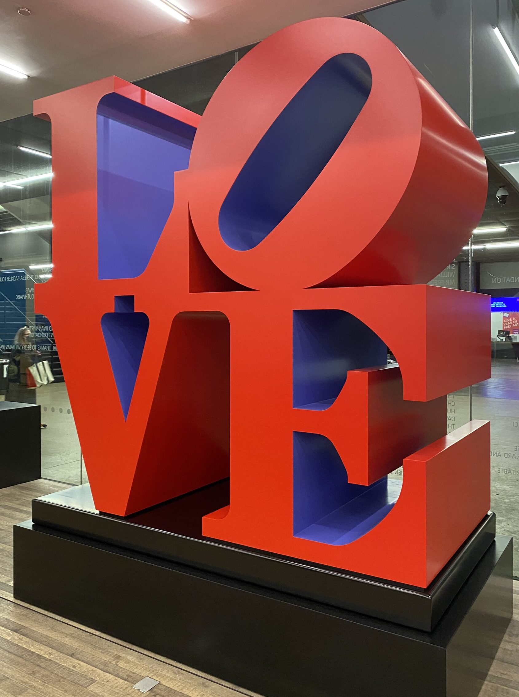 A large red sculpture spelling out the word LOVE, at Tate Modern in London