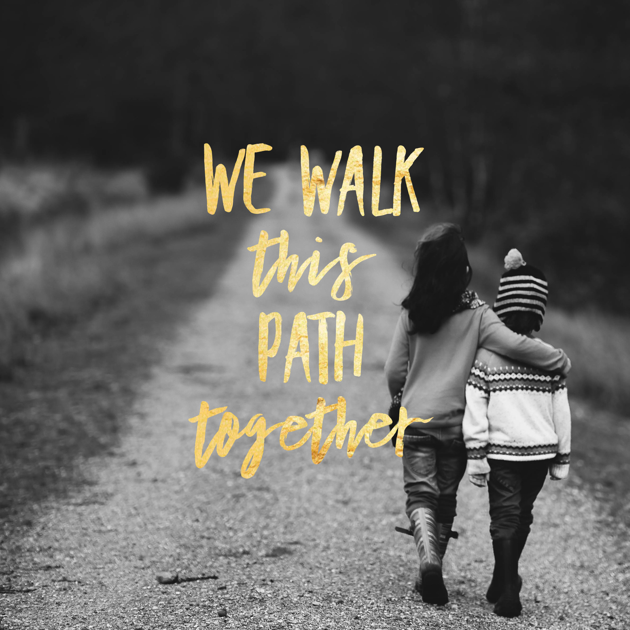A photograph of two children walking away hand in hand, overlaid with the words we walk this path together.