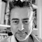 Black and white portrait of Alex Golding.